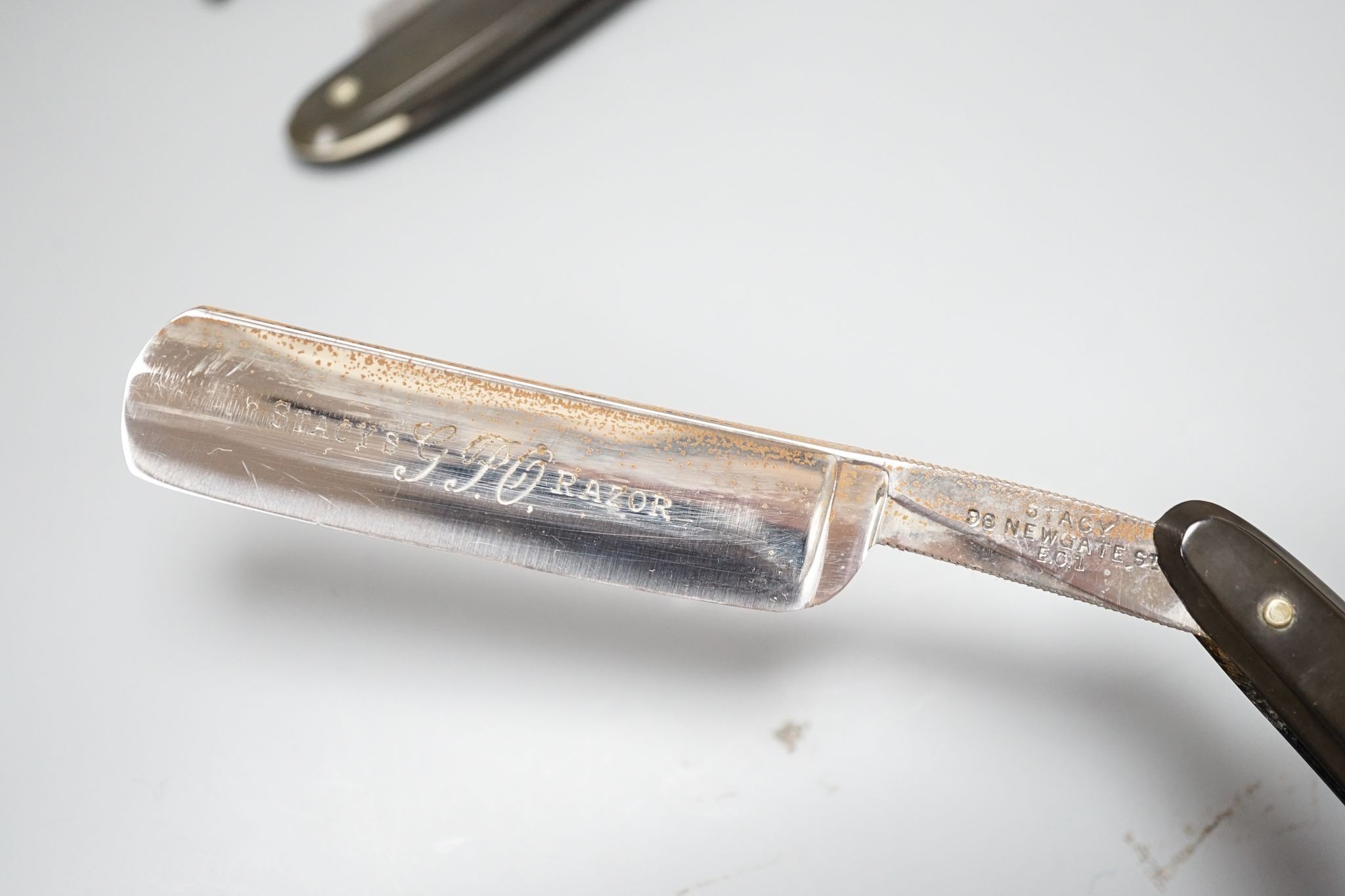 A Georgian leather cased cut throat razor and two similar 19th century razors